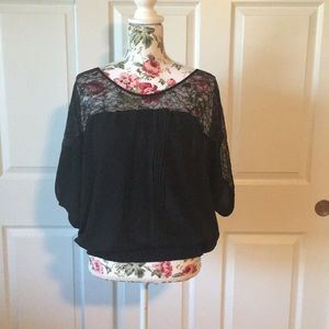 Black blouse with lace detail.